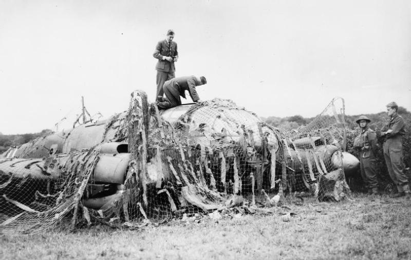 3 RAF personnel inspecting Heinkel He 111P 12 July 1940 IWM