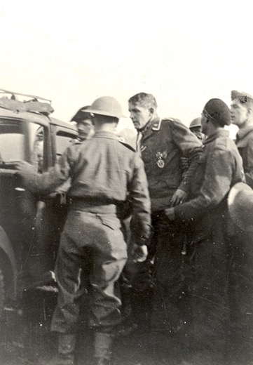 Pilot Uffz Schumann being bundled away